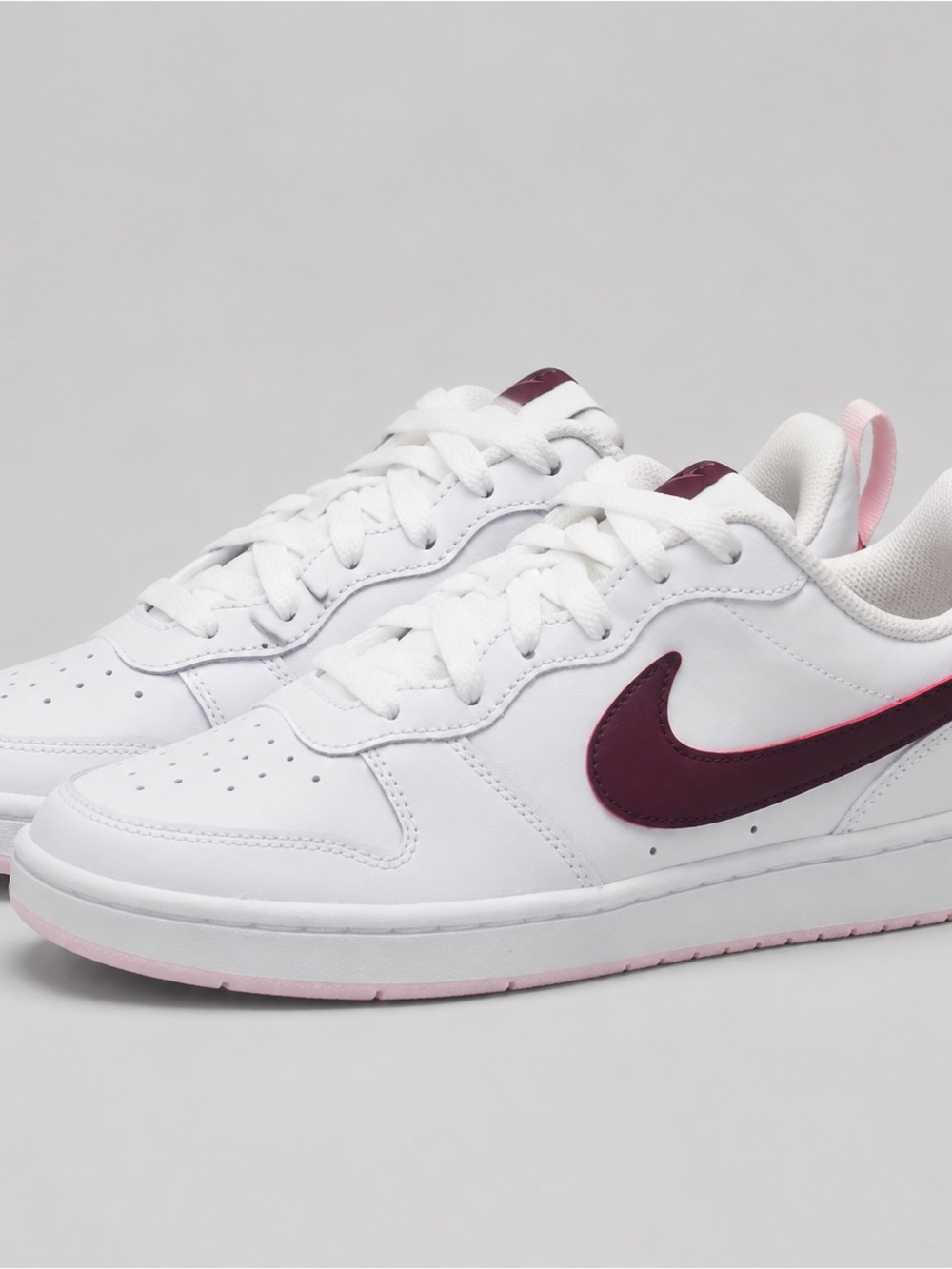 Nike Kids White Sneakers with Burgundy Swoosh and Pink Details